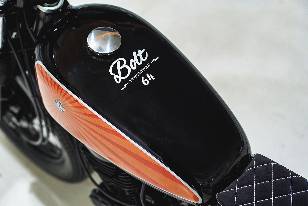 close view of the Bolt logo on the black tank with sunburst orange paint