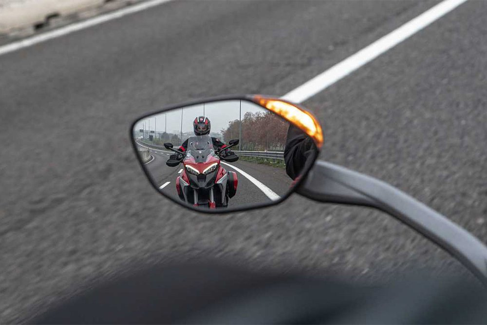 A Ducati Multistrada V4 S seen in the rearview mirror of another Multistrada V4 S.