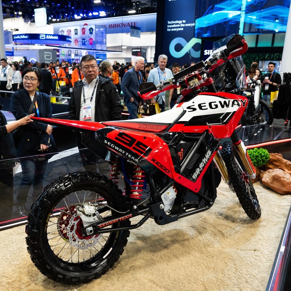A crowd gathers around Segway's X1000 electric rally bike at CES 2025.
