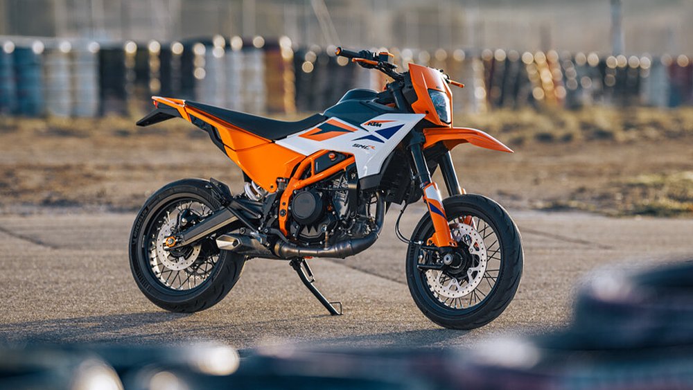 The 2025 KTM 390 SMC R stands on an empty kart track. 