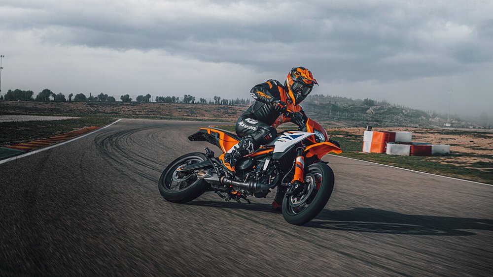 A rider skids the KTM 390 SMC R around a turn on the track.