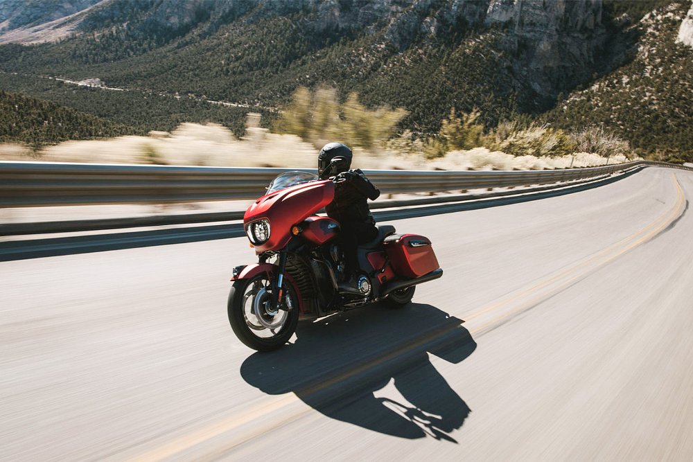 A rider bends the 2025 Indian Chieftain PowerPlus around a canyon road. 
