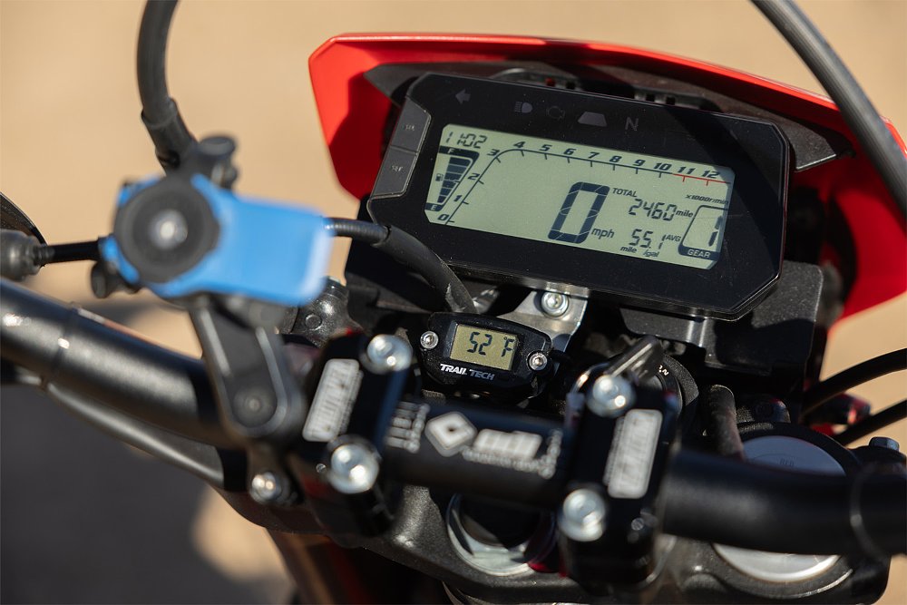 The encumbered dash of Ari's CRF300L, including a Quad Lock phone mount and TrailTech temperature meter.