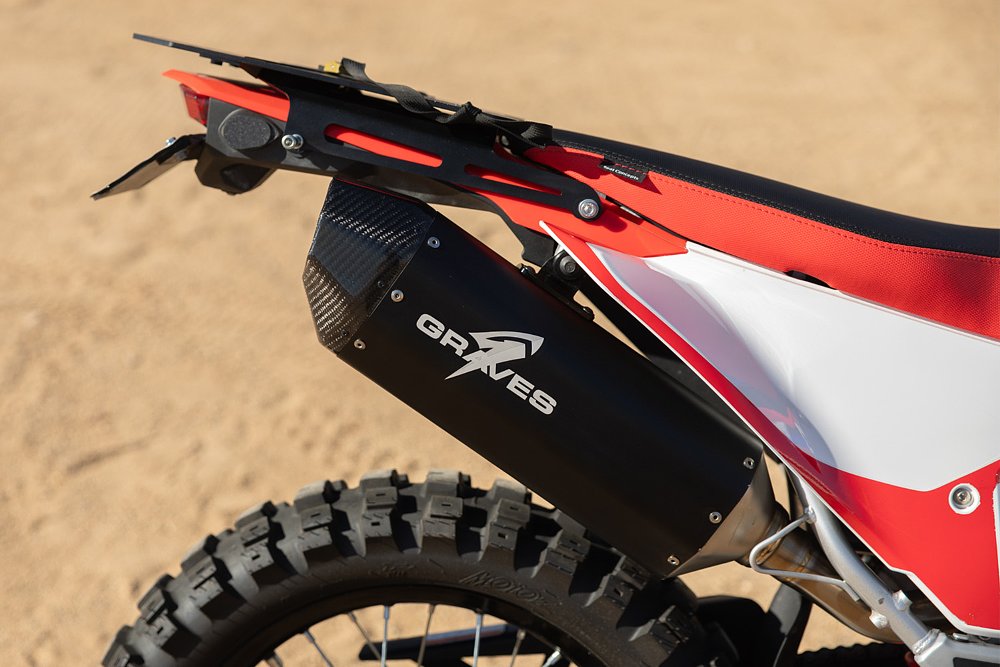 A close-up of the Graves exhaust system installed on Ari's CRF300L.