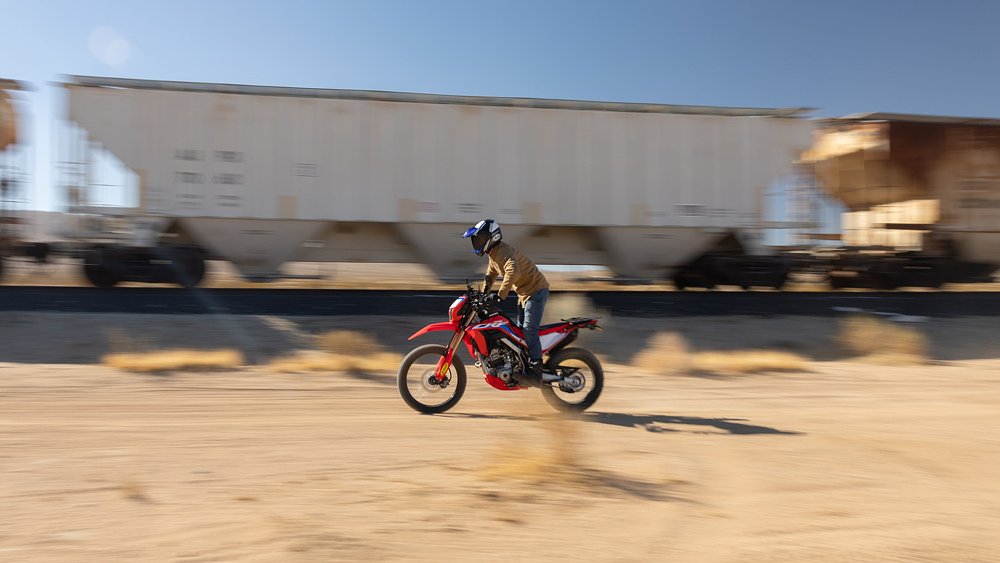 Dustin blast down a desert trail on Ari's CRF300L.