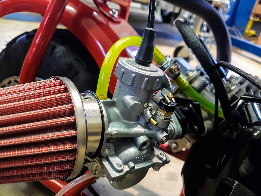 old style slide carburetor with air filter attached to the side