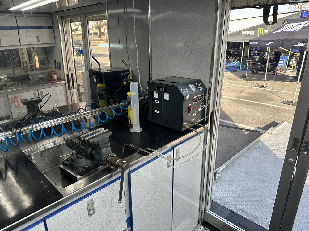 Suzuki SuperMotocross truck suspension workshop detail.