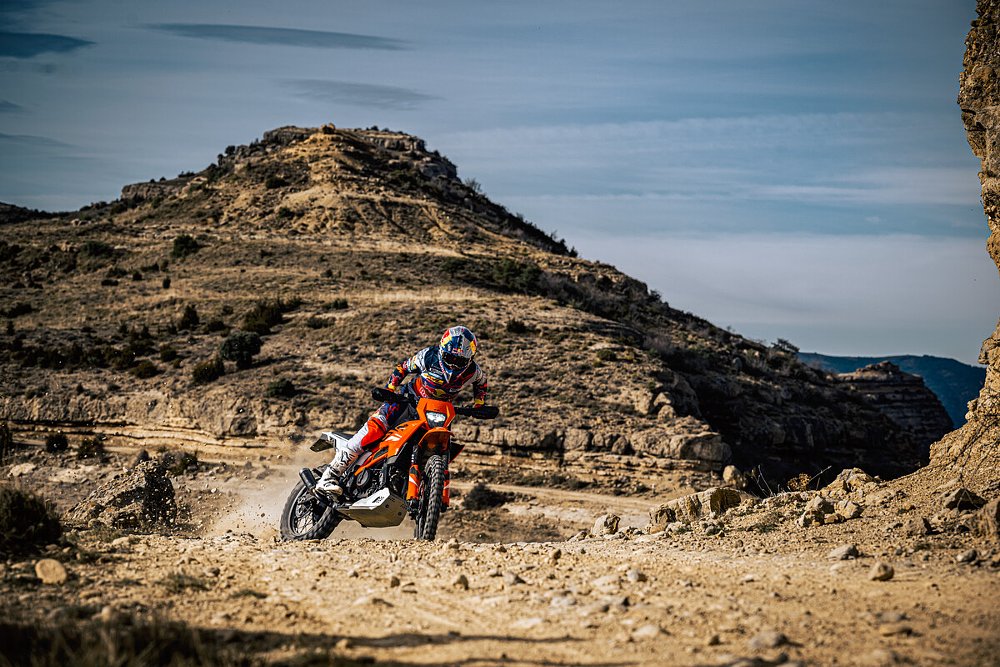A 390 Enduro R sliding the rear of the bike up a rocky hill.