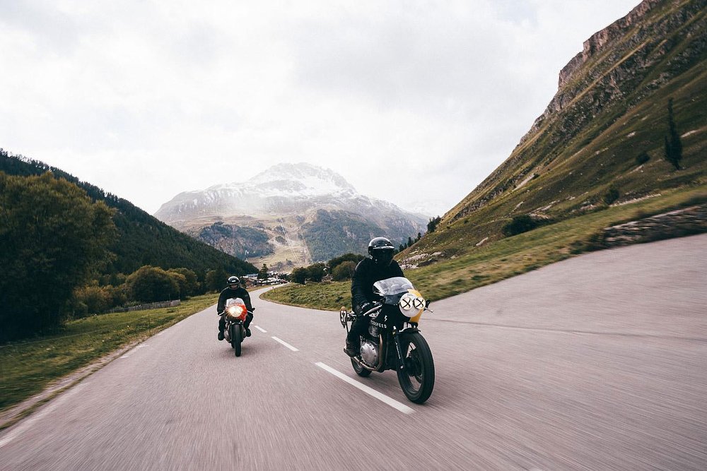 the two Royal Enfields on the road in the Alps