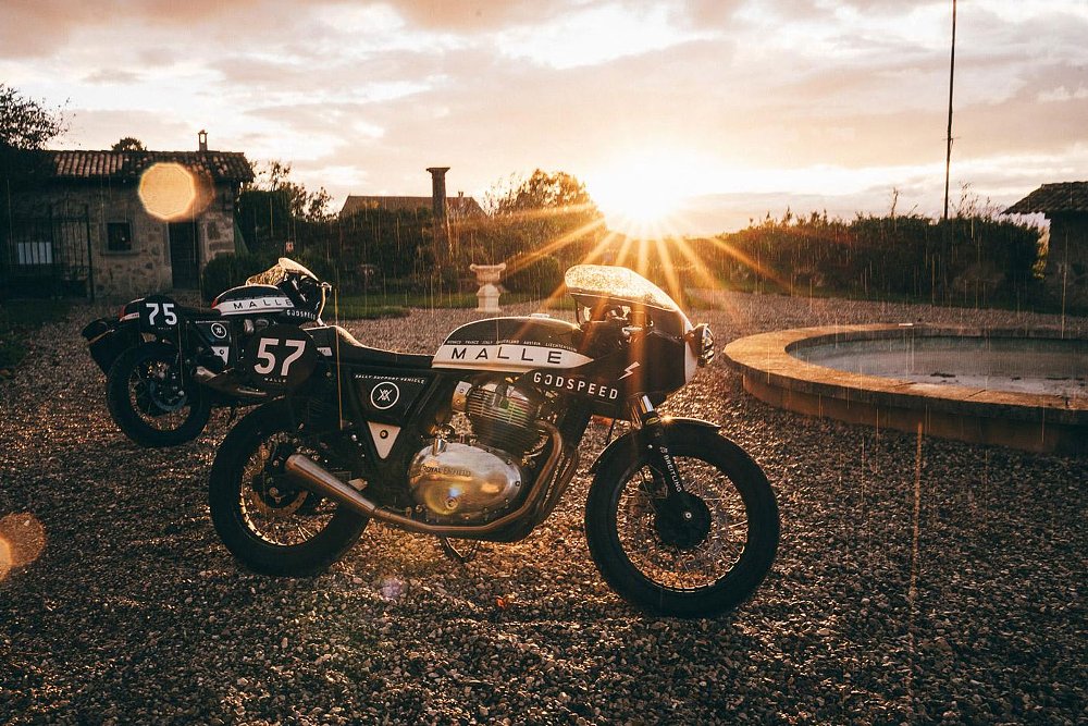 parked rally support bike showing the black side with the sun setting behind