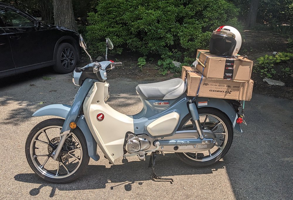 photo of the Super Cub with RevZilla and Comoto boxes on the rear rack