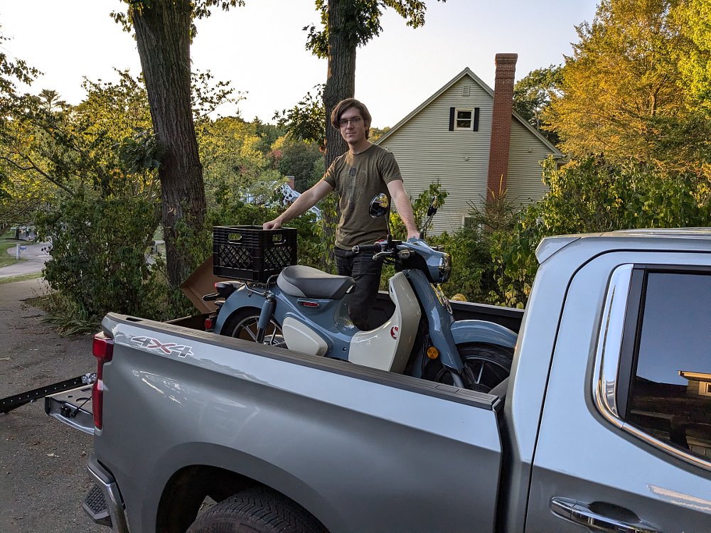 Leo with the Super Cub loaded into the back of a pickup truck