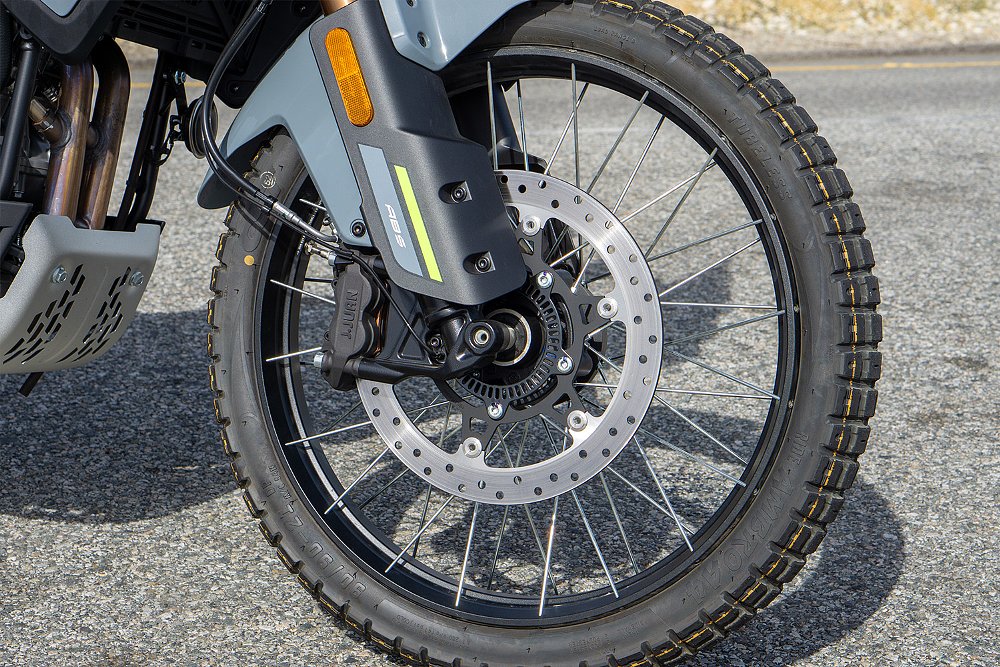 A close-up of the 21-inch front wheel on CFMOTO's Ibex 450. 