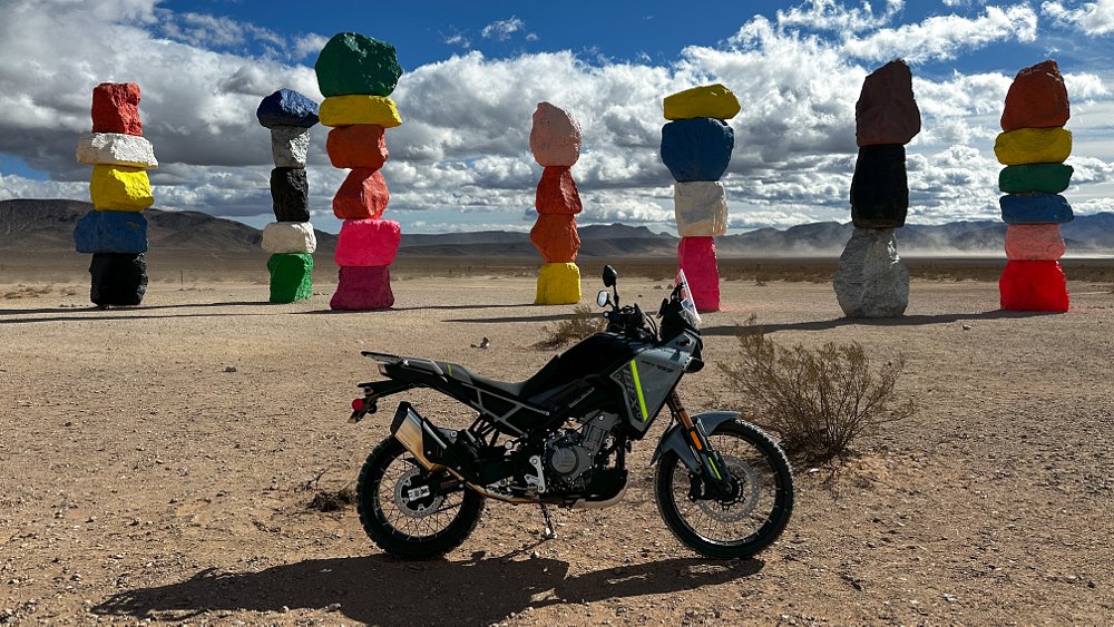 The 2025 CFMOTO Ibex 450 staged before the Seven Magic Mountains in Nevada. 