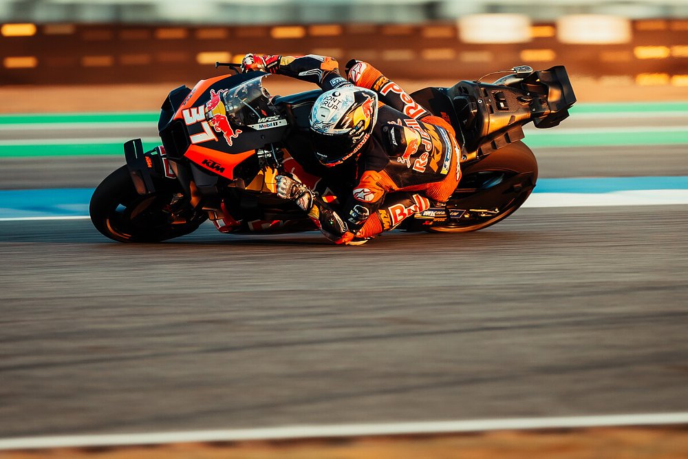 Acosta on the orange and black KTM racing in testing