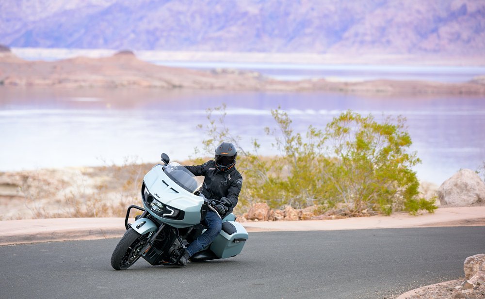 author on a white Indian Challenger leaned over on a curve in the road