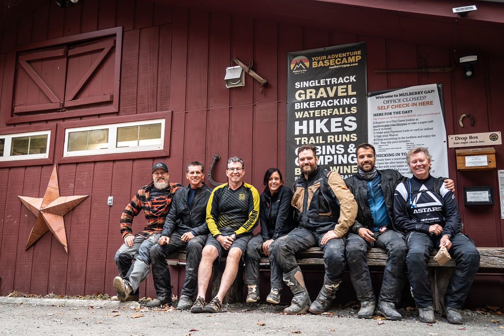 A group picture of Justin, Tim, Tom, Jocelin, Mani, Tobias, and Kirk sitting in front of a barn.