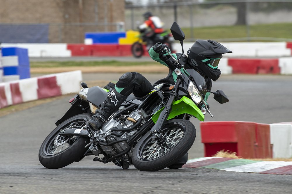 rider on a race track on a green KLX300SM