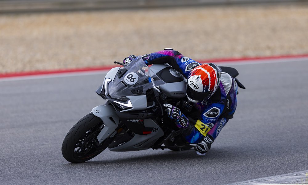 rider on the 675 leaned over in a corner on the track