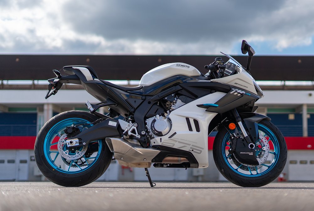 side view of a white 675 parked at the track