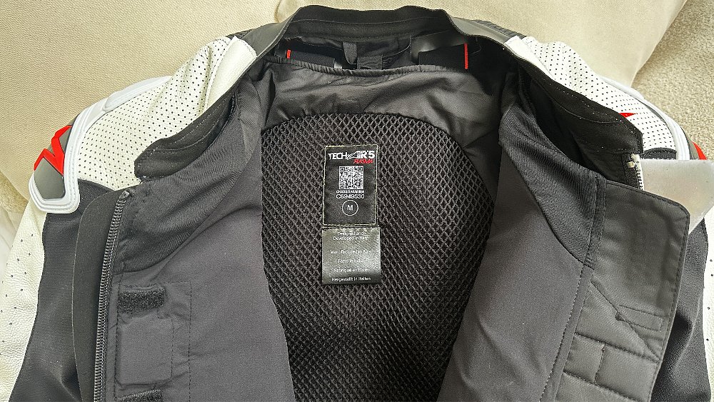 A close-up shot of the Tech-Air 5 Plasma clipped into an Alpinestars race suit.