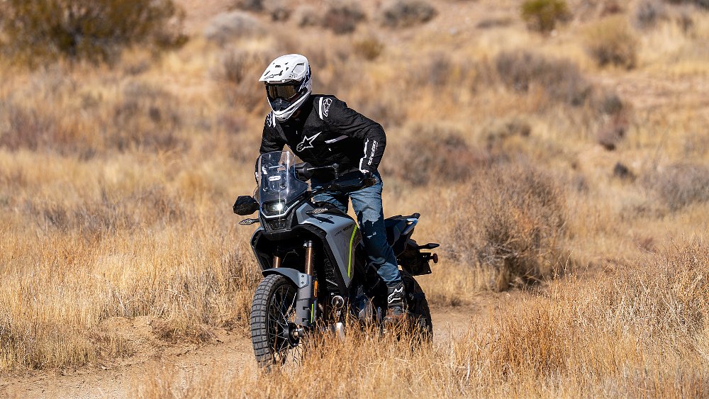 Dustin rides the CFMOTO Ibex 450 off-road while wearing Alpinestars gear.