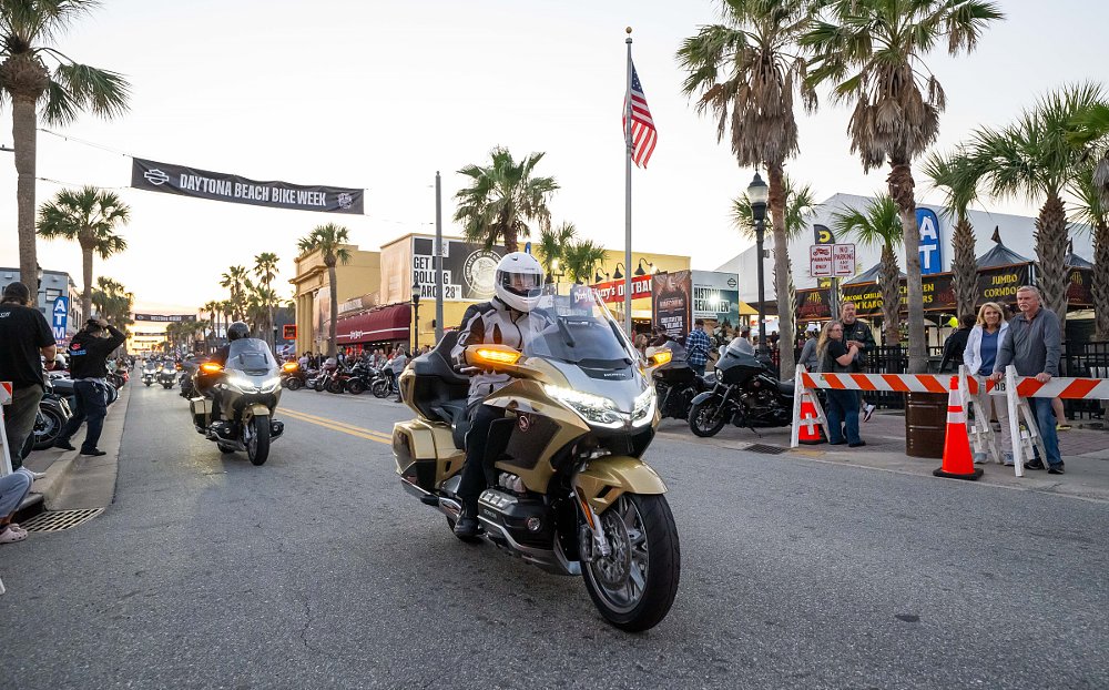 Gold Wings riding underneath the Welcome to Bike Week banner on Main Street in Daytona Beach