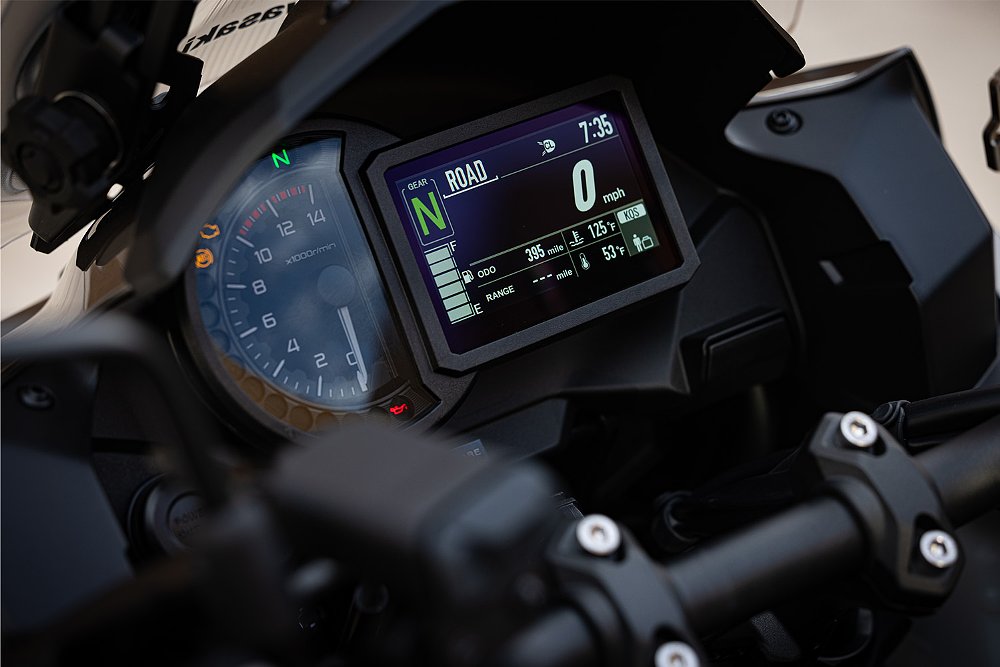 A close-up of the Kawasaki Versys 1100 SE LT's analog tachometer and full-color TFT dash.