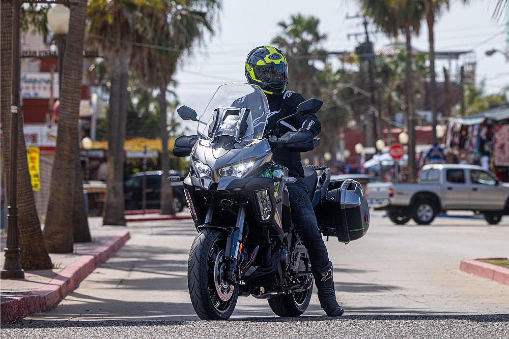 Dustin mounts the Versys 1100 SE LT with one foot planted on the ground.