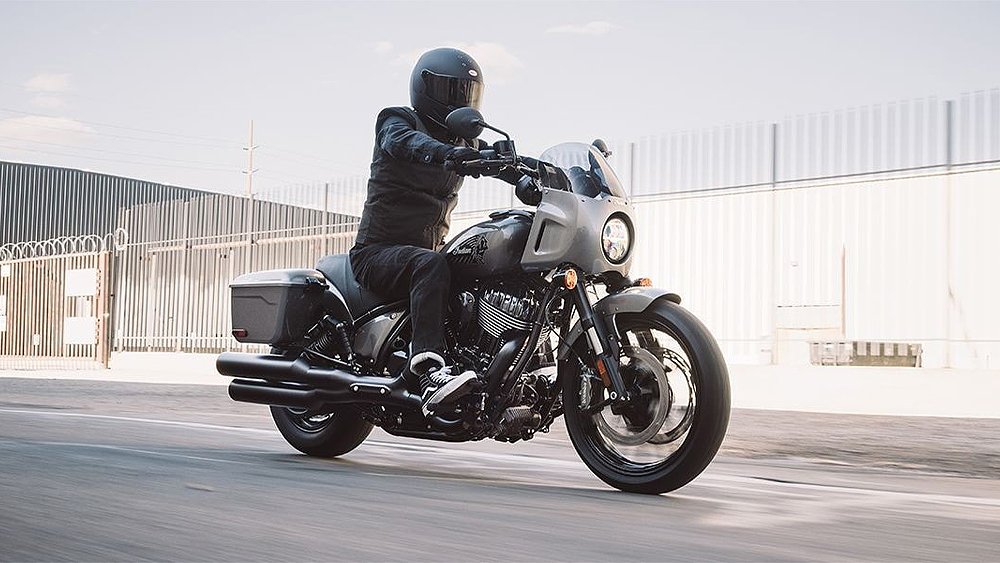 A rider pilots the Indian Sport Chief RT down an industrial street. 
