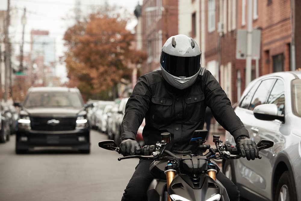 rider on a motorcycle on a busy city street