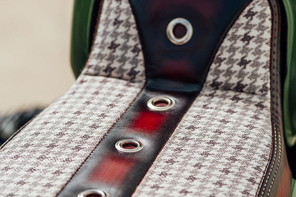 detail photo of plaid seat with red leather accents
