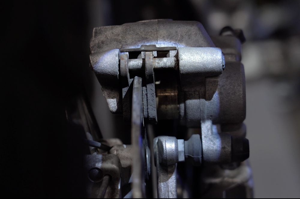 Inspecting brake pads by looking in the caliper