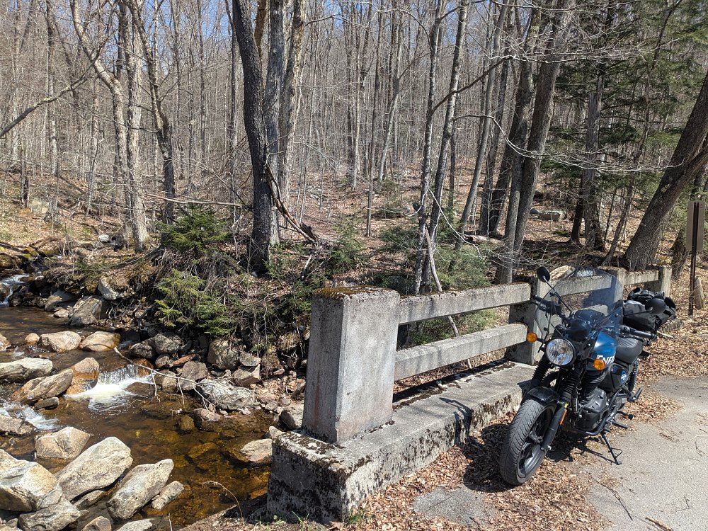 the Hunter parked on a small bridge in the woods