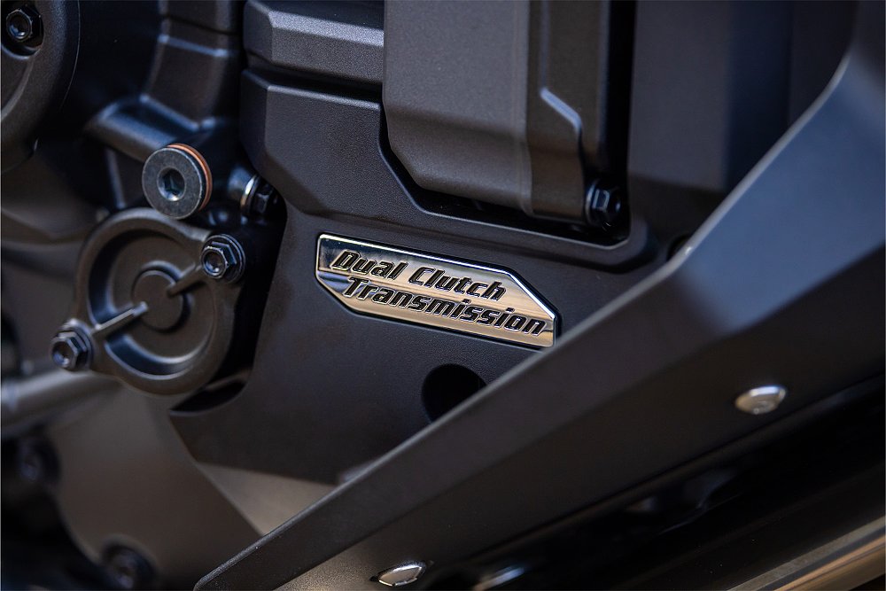 A close-up of the Dual-Clutch Transmission badge on the NT1100's engine.
