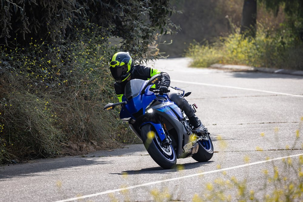 rider on a blue Yamaha sport motorcycle in a curve, leaned over but not extreme