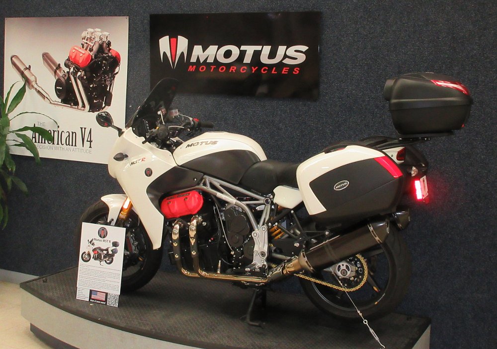 A white Motus motorcycle on display in the museum