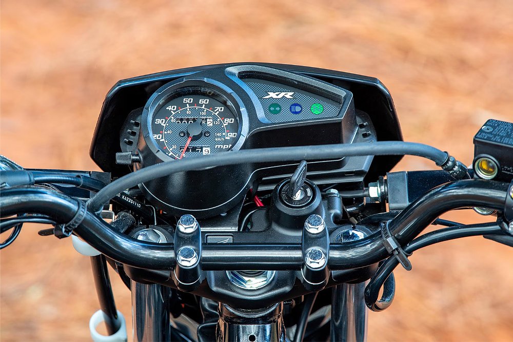 A close up of the Honda XR150L's analog dash.