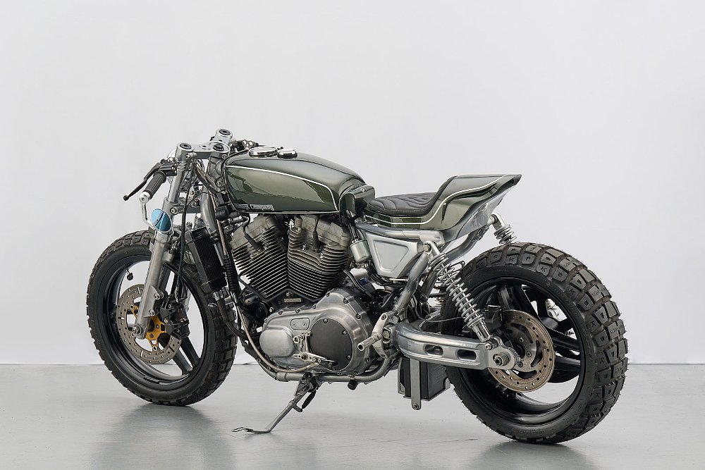 rear angle studio photo of the silver and green cafe racer