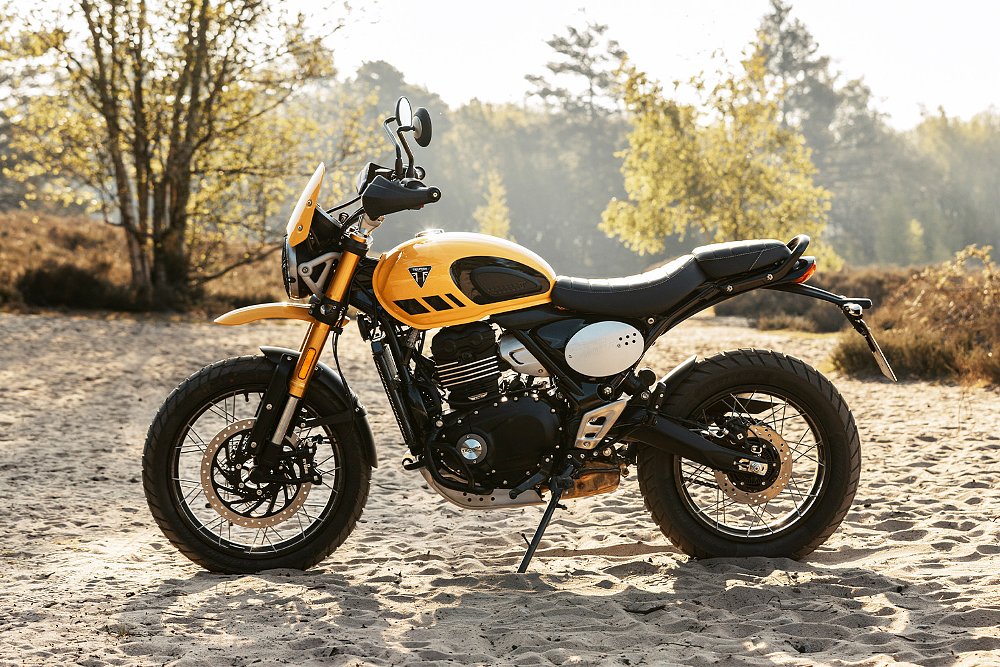 A side profile of the Scrambler 400 XC while it's staged on a sand trail.