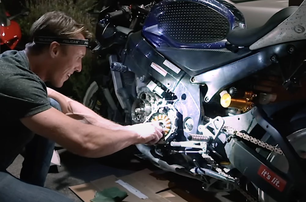 Ari fixes Dave the Gixxer while wearing a headlamp