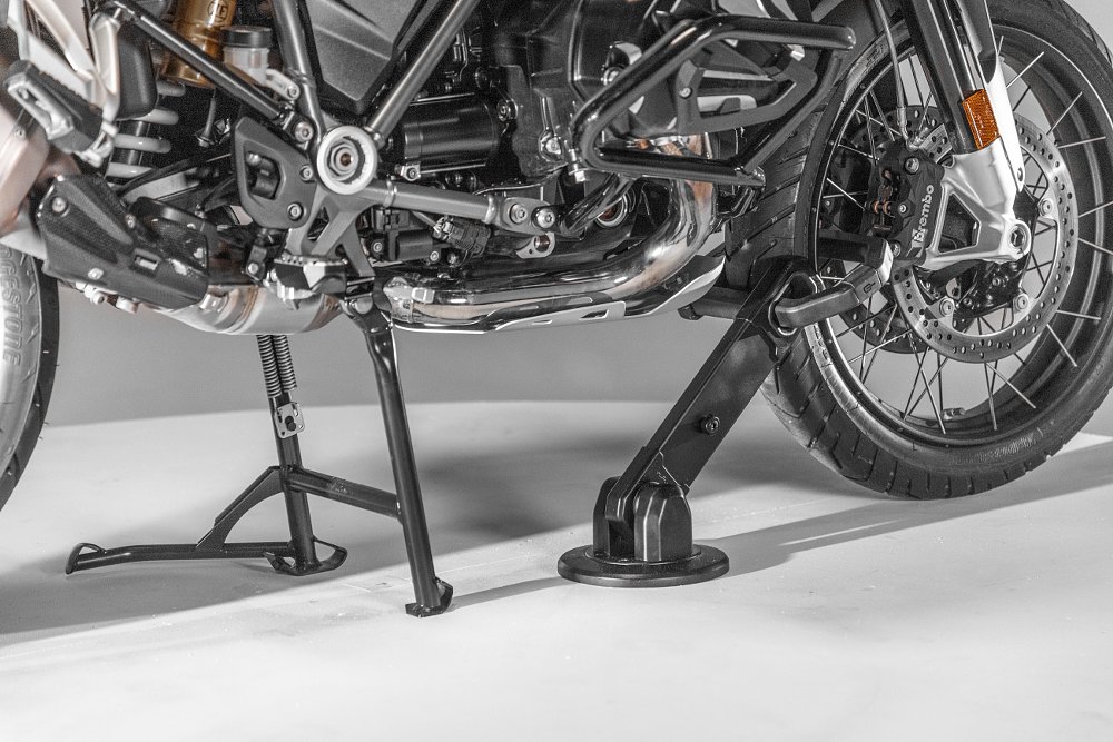 photo of anchor in concrete with a lock attached to a BMW motorcycle's wheel