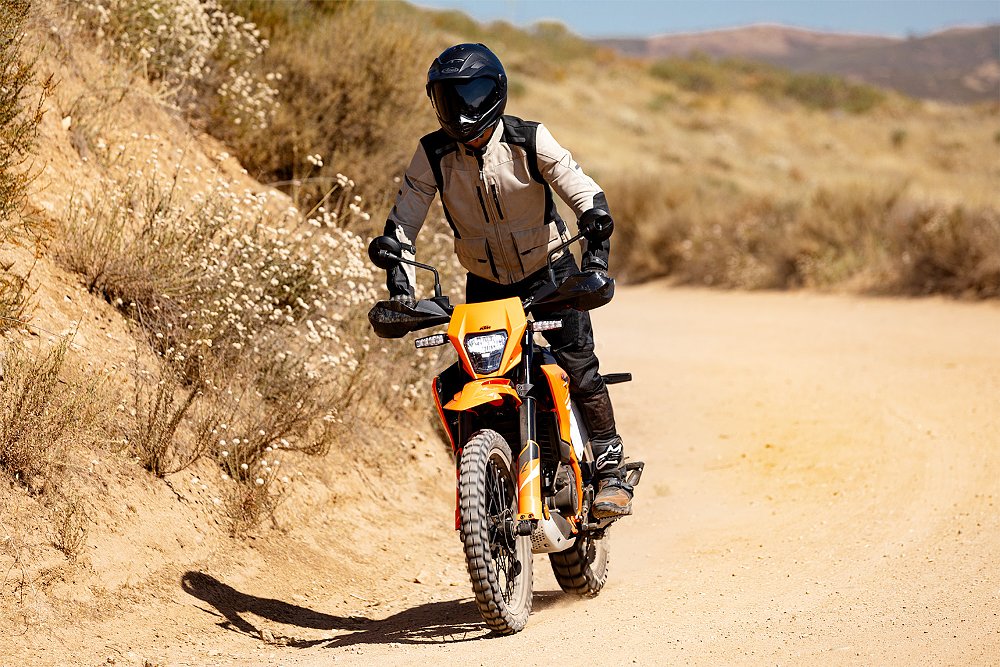 Dustin standing on the 390 Enduro R's footpegs while riding off-road.