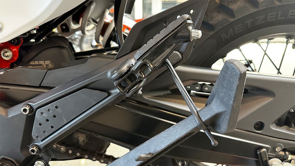 A close-up of the 390 Enduro R's rubber kickstand restraining strap. 