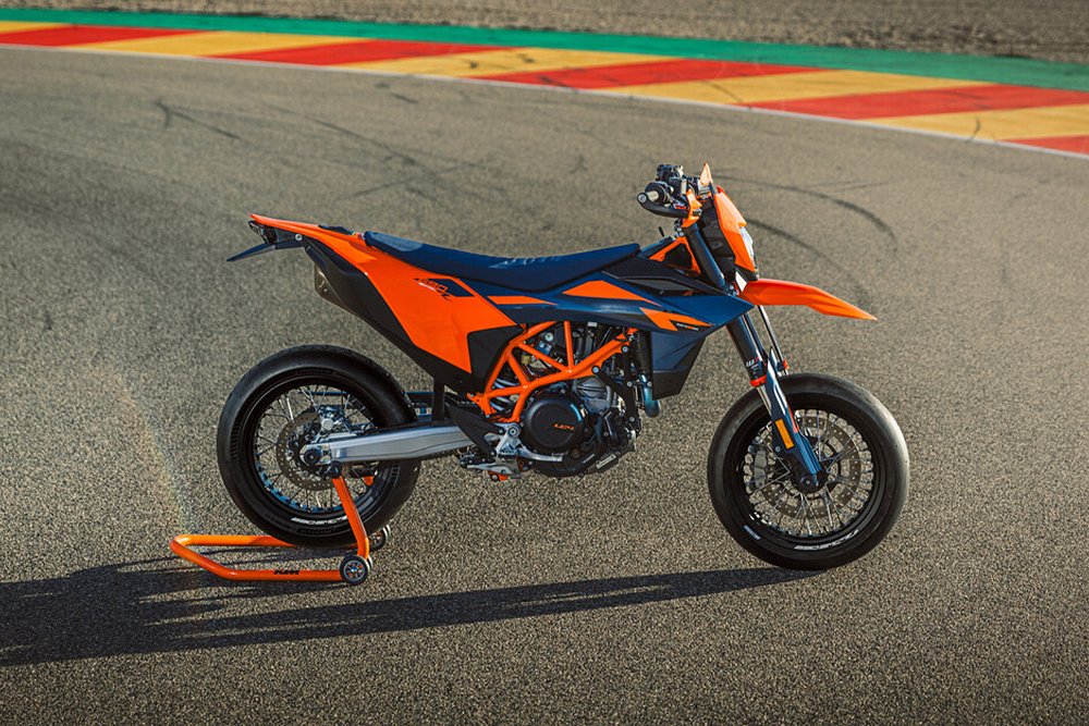 A profile shot of the 690 SMC R supermoto parked on a kart track.