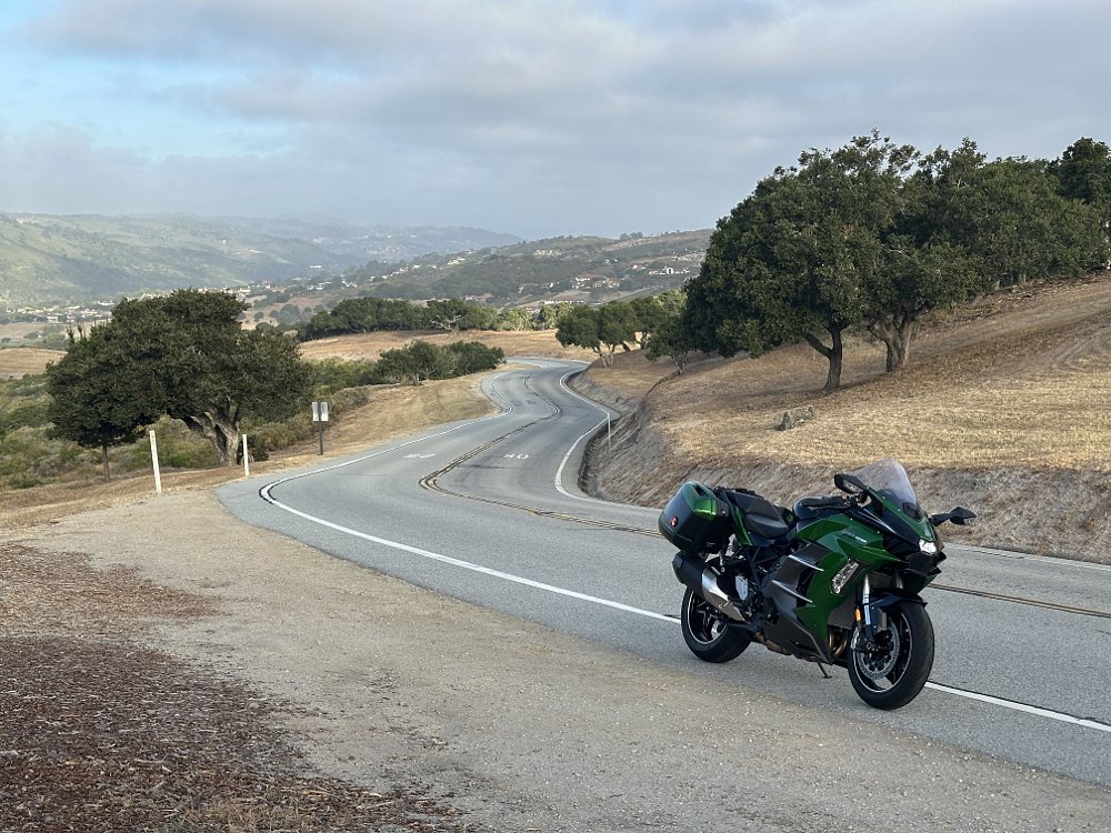 2025 Kawasaki H2 SX SE parked on the side of the access road leading to WeatherTech Raceway Laguna Seca.