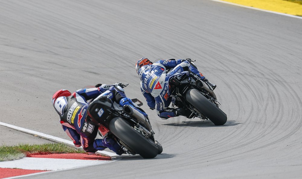 view from behind as Beabuier chases Fong through a curve on the track