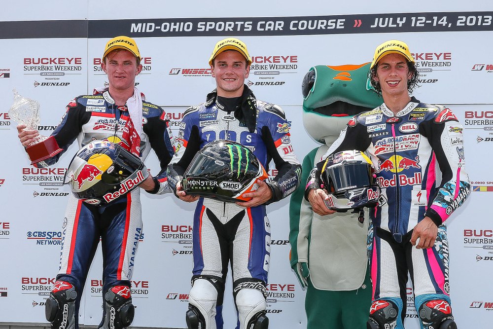 three young racers hold trophies on the podium at Mid-Ohio Sports Car Course in 2013
