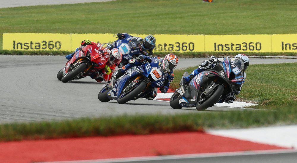 the four racers in a line through a curve at Mid-Ohio
