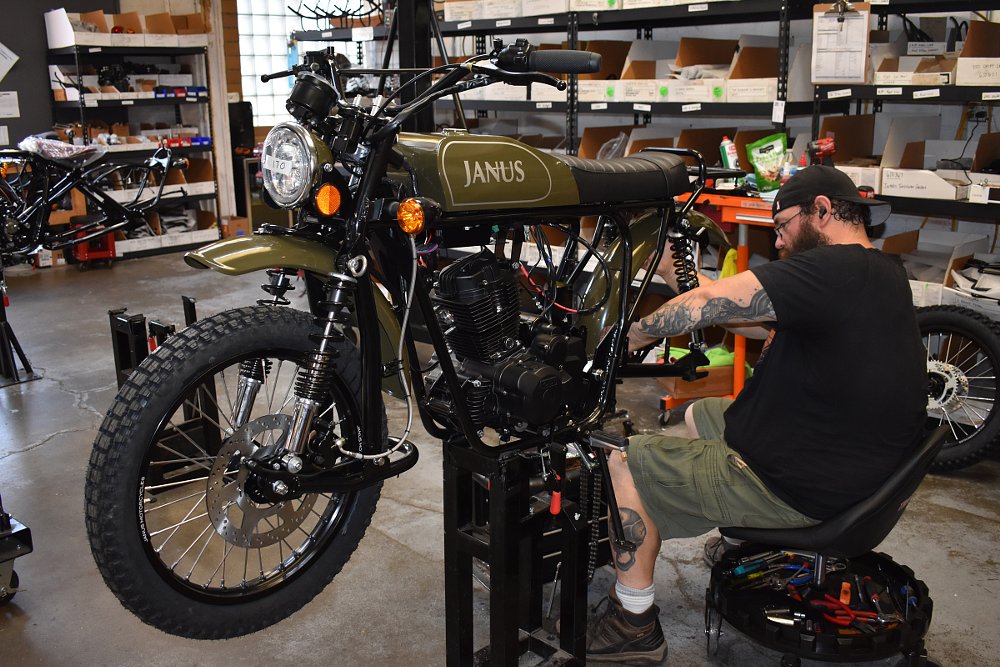 worker assembling a Janus motorcycle in the shop